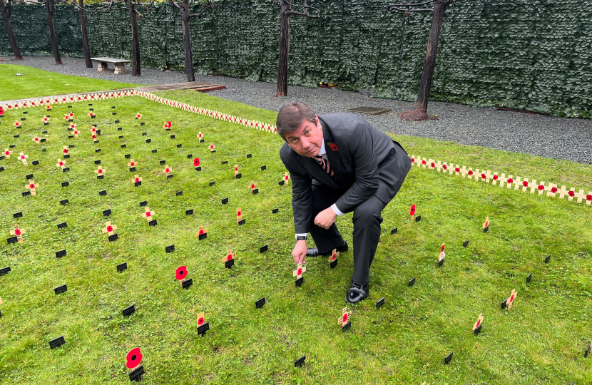 Stephen plants a poppy tribute.