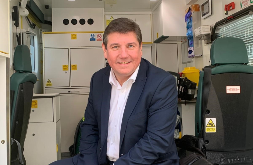 Stephen sitting in Ambulance on a visit to EEAST.