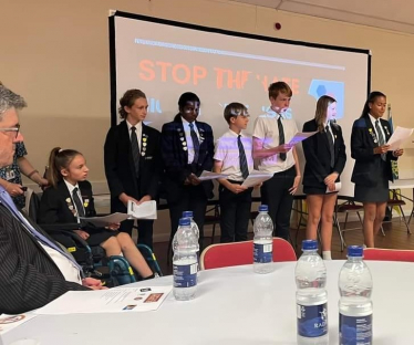 Mr Safet Vukalic watches Woodlands School pupils give a presentation at the "Stop the Hate" Event.