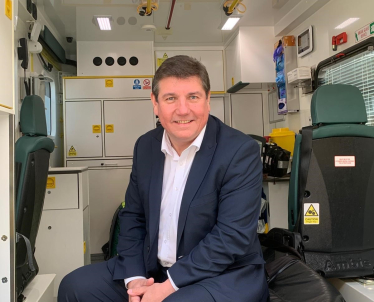 Stephen sitting in Ambulance on a visit to EEAST.